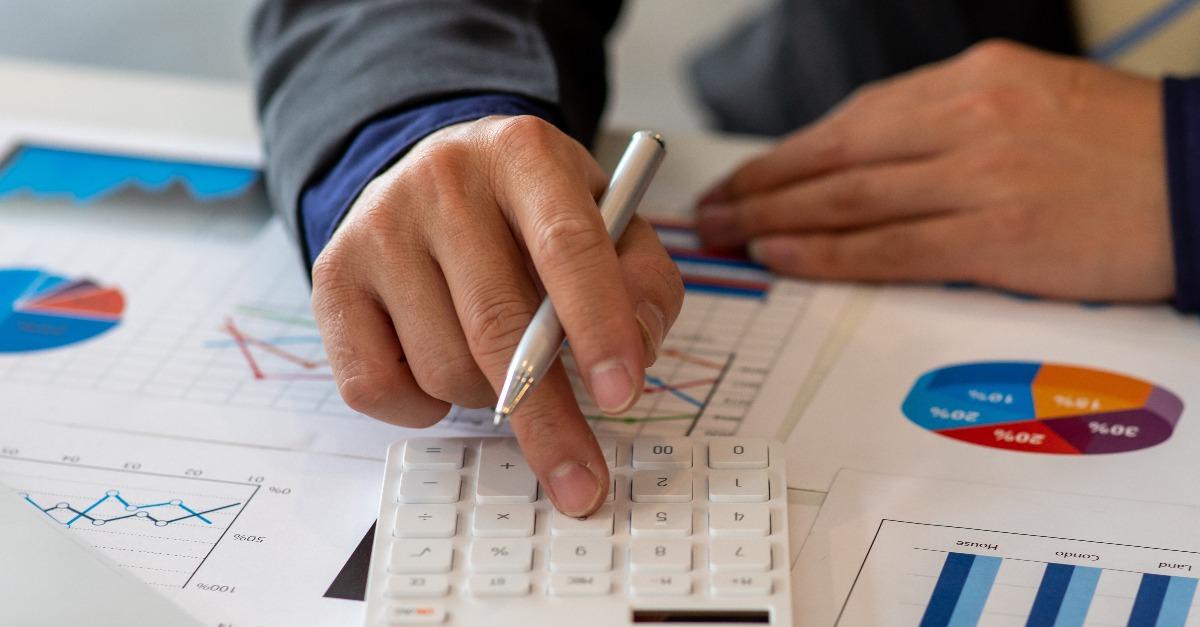 Business man using calculator and laptop
